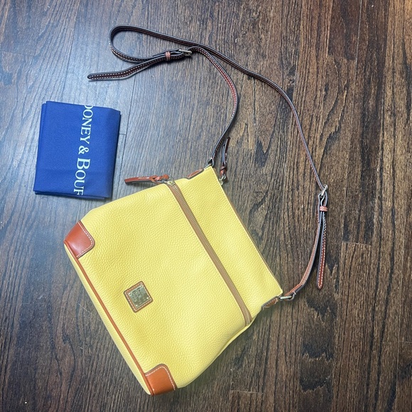 Dooney & Bourke Handbags - Dooney and Bourke soft yellow purse. Brand new with dust bag.